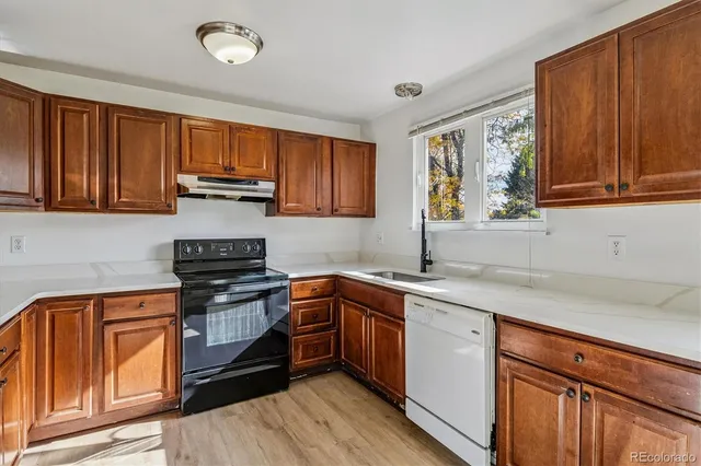 a kitchen with stainless steel appliances granite countertop a sink stove and cabinets