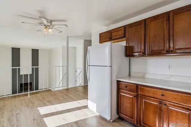 a kitchen with stainless steel appliances granite countertop a refrigerator a stove and a sink