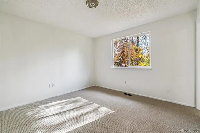 a view of room with window and wooden floor