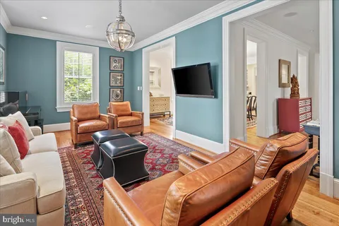 a hallway with furniture and a potted plant