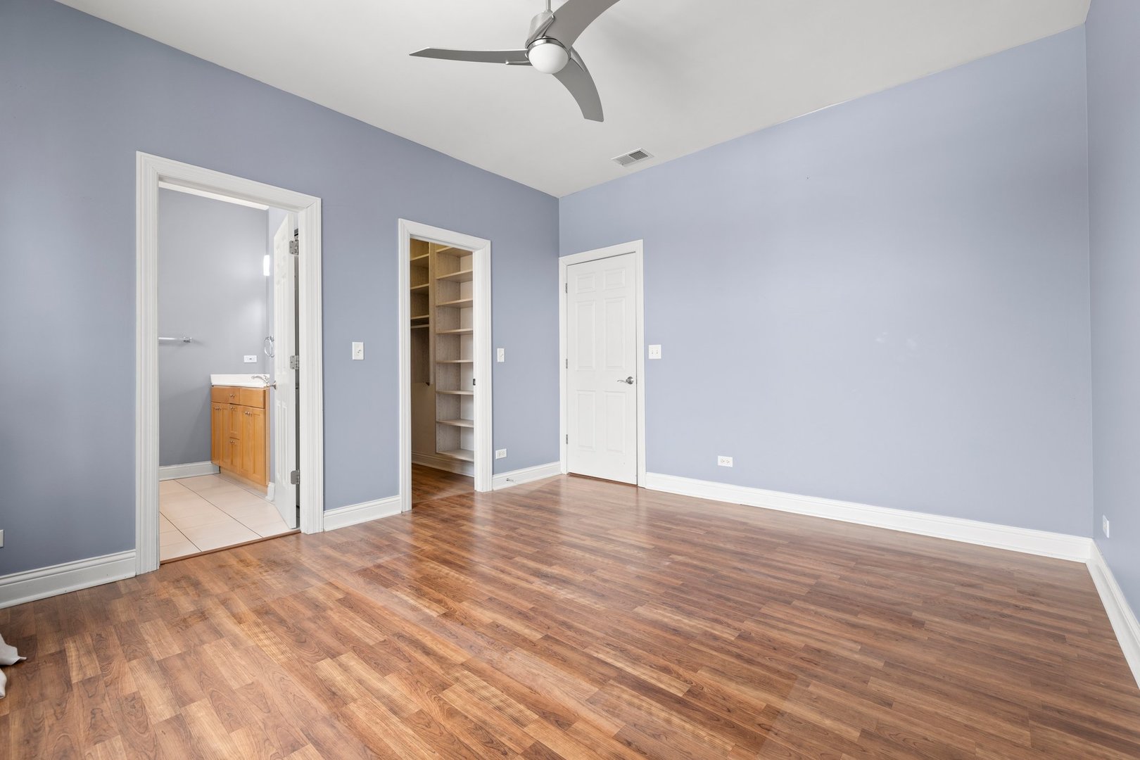 1122 North Oakley Boulevard, Unit C Chicago, IL 60622 - Photo 14 of 23 a view of an empty room with wooden floor and a window