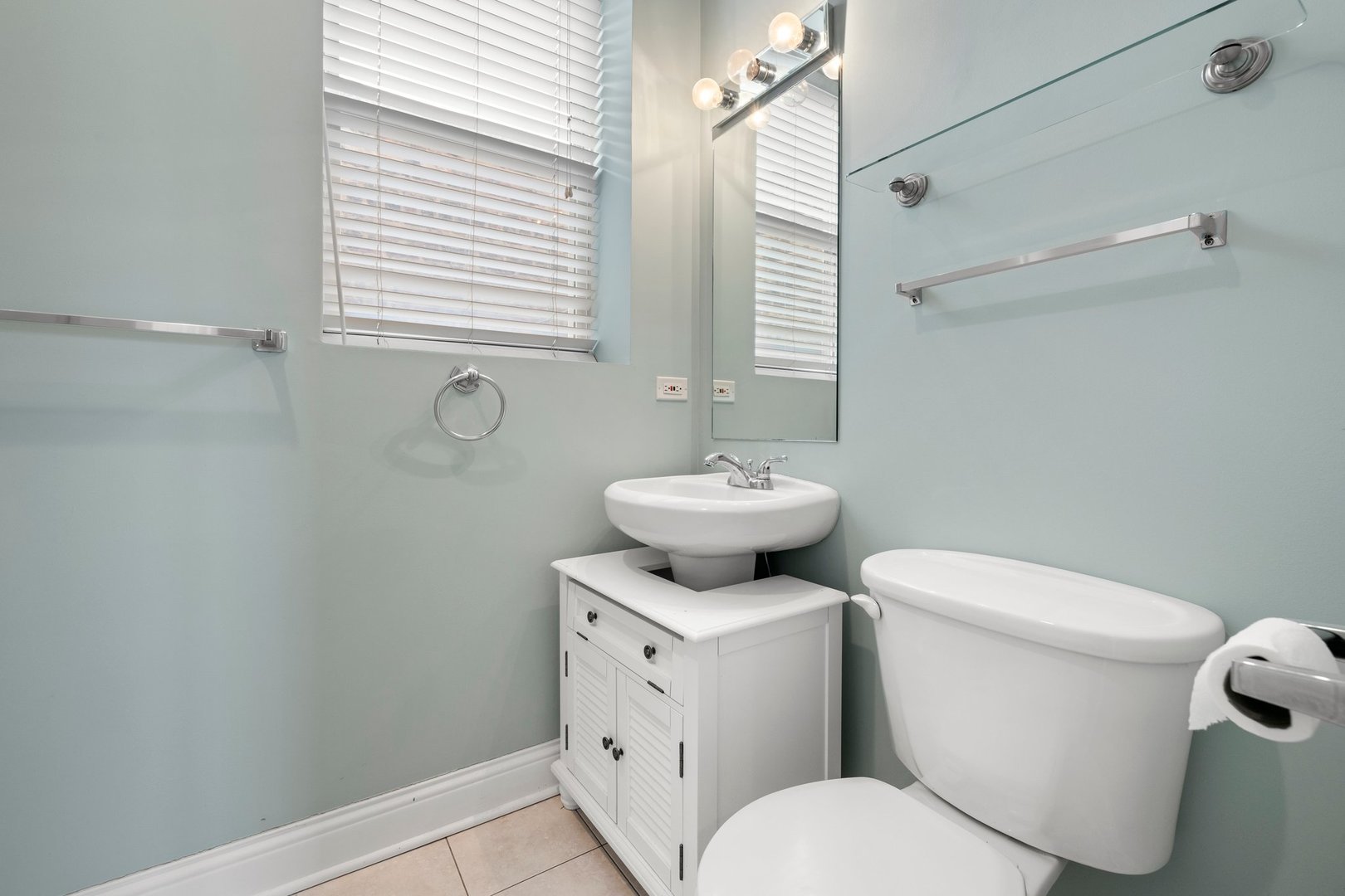 1122 North Oakley Boulevard, Unit C Chicago, IL 60622 - Photo 19 of 23 a white toilet sitting next to a bathroom sink