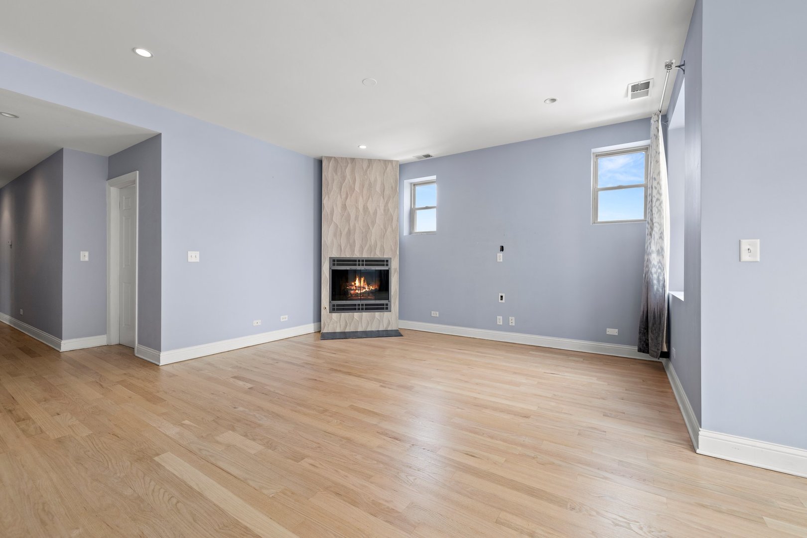 1122 North Oakley Boulevard, Unit C Chicago, IL 60622 - Photo 7 of 23 wooden floor in an empty room with a fireplace