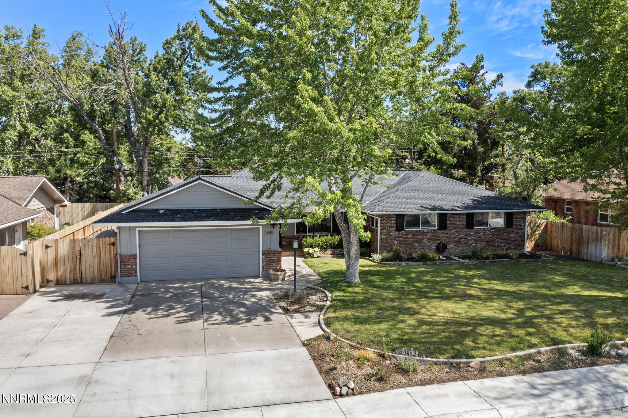 1445 California Avenue Reno, NV 89509 - Photo 1 of 29 a front view of a house with a garden