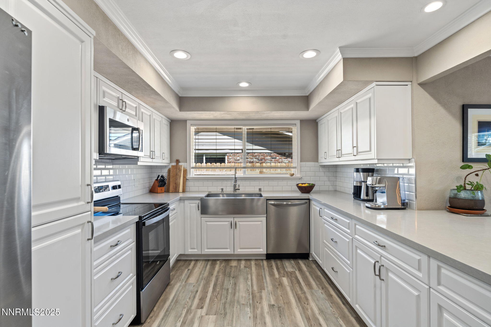 1445 California Avenue Reno, NV 89509 - Photo 12 of 29 a kitchen with a sink stove cabinets and wooden floor
