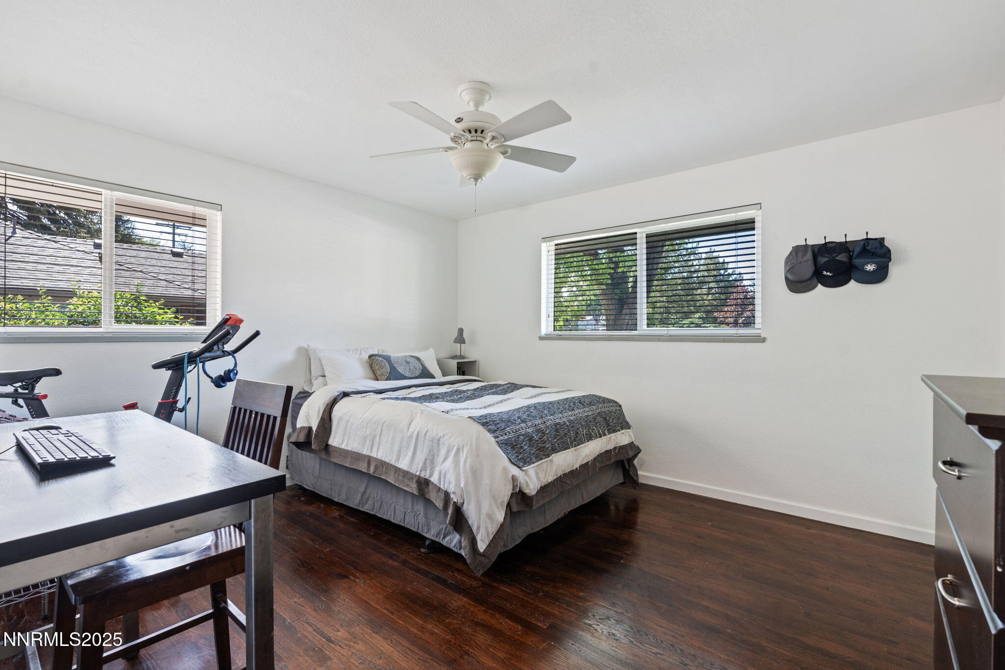 1445 California Avenue Reno, NV 89509 - Photo 20 of 29 a bedroom with a bed a large window and wooden floor