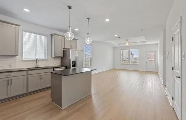 a kitchen with kitchen island a counter space a sink and cabinets