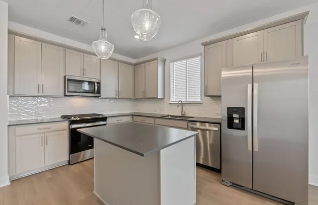 an entryway space with wooden floor and window