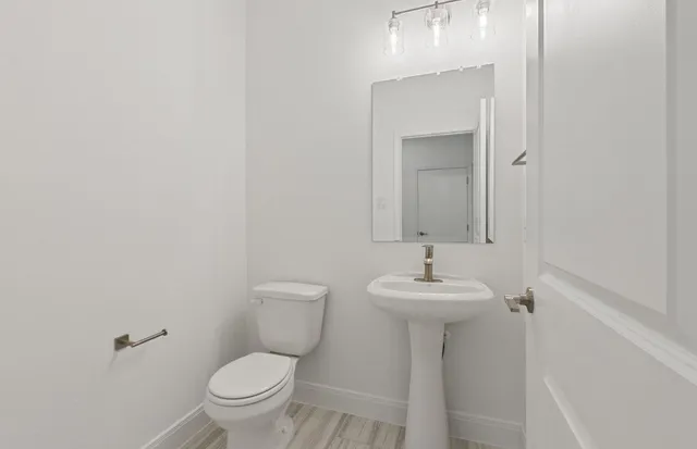 an empty room with a kitchen and a ceiling fan kitchen view