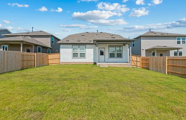 a view of a house with a garden and yard