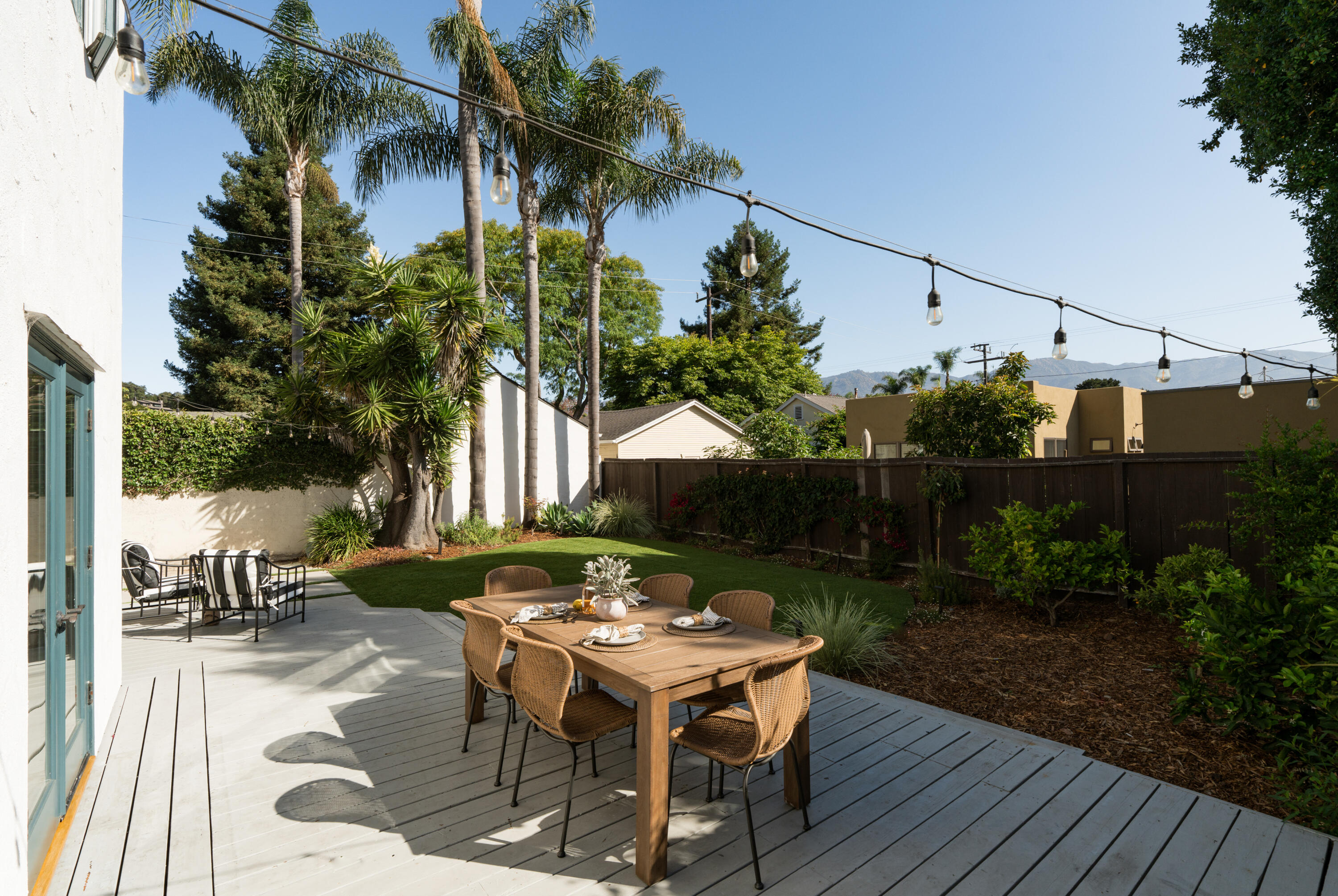 1740 Clearview Road Santa Barbara, CA 93101 - Photo 9 of 21 a backyard of a house with table and chairs plants and large trees