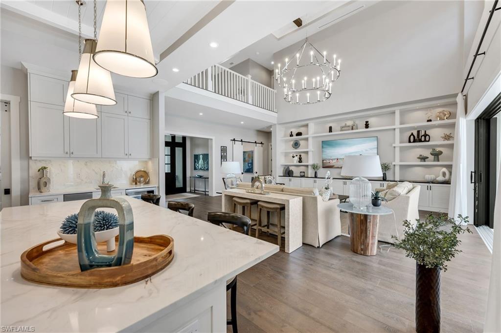 2025 Crayton Road Naples, FL 34102 - Photo 13 of 36 a kitchen with stainless steel appliances granite countertop a stove refrigerator and cabinets