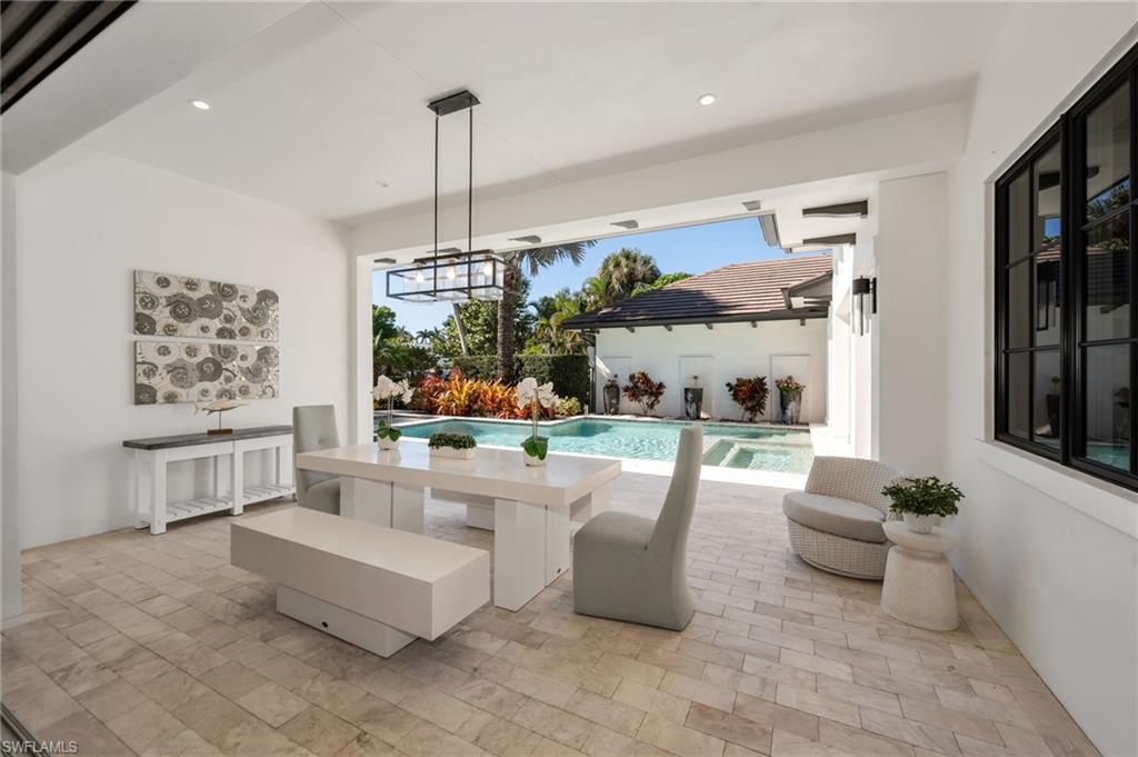 2025 Crayton Road Naples, FL 34102 - Photo 15 of 36 a living room with furniture and a large window