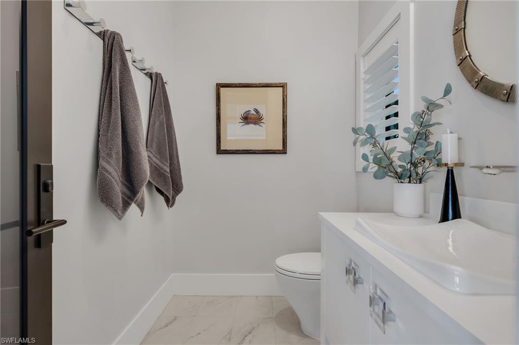 2025 Crayton Road Naples, FL 34102 - Photo 18 of 36 a bathroom with a sink and a toilet