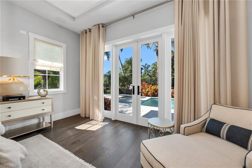 2025 Crayton Road Naples, FL 34102 - Photo 21 of 36 a bedroom with furniture and a window