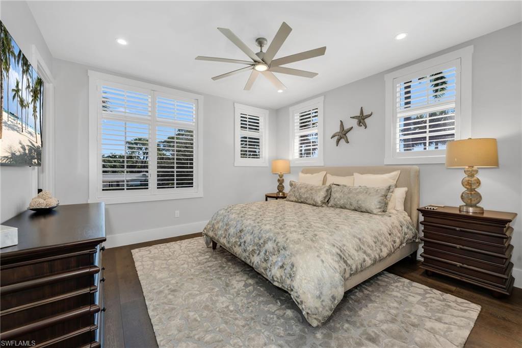 2025 Crayton Road Naples, FL 34102 - Photo 30 of 36 a bedroom with a large bed and a window