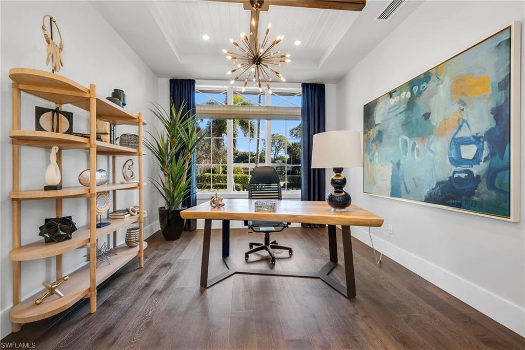 2025 Crayton Road Naples, FL 34102 - Photo 9 of 36 a view of a dining room with furniture a chandelier and wooden floor