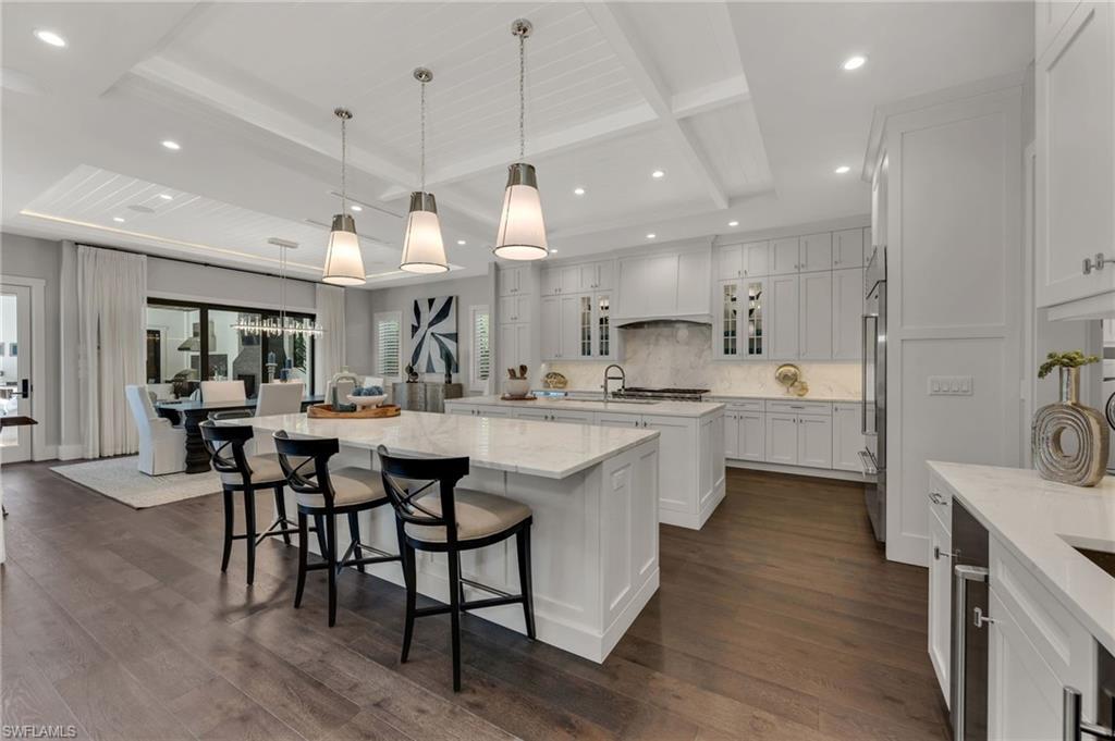 2025 Crayton Road Naples, FL 34102 - Photo 10 of 36 a large kitchen with a table and chairs