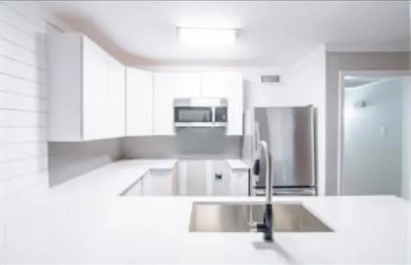 a kitchen with a refrigerator and a sink