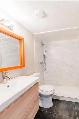 a bathroom with a sink a toilet and a shower