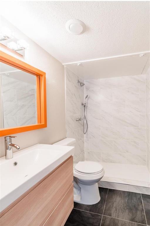 5808 Sandhurst Lane, Unit A Dallas, TX 75206 - Photo 3 of 9 a bathroom with a sink a toilet and a shower