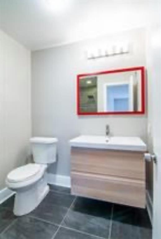 5808 Sandhurst Lane, Unit A Dallas, TX 75206 - Photo 4 of 9 a bathroom with a toilet sink and mirror