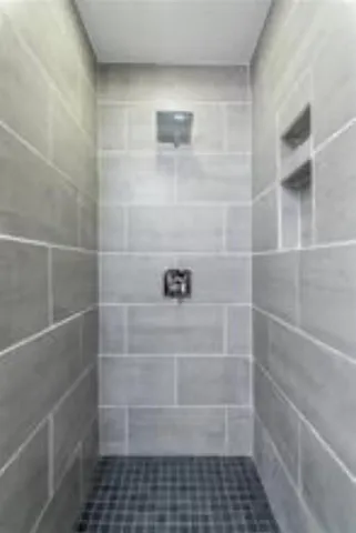 a bathroom with a glass door shower