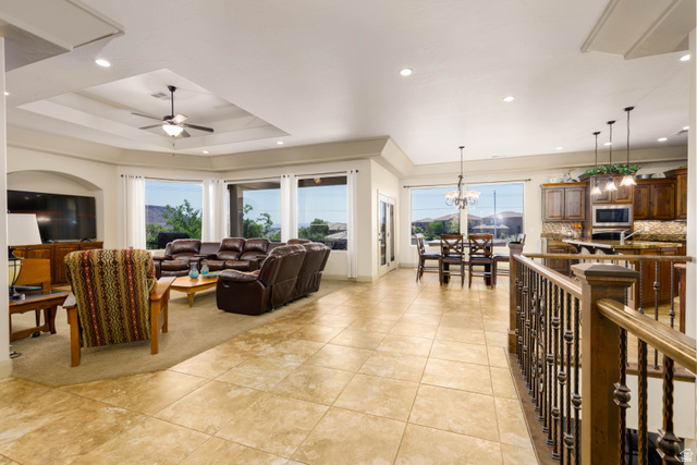 2005 West 450 S Circle St. George, UT 84770 - Photo 9 of 57 Expansive open-concept living space featuring neutral tile flooring, recessed lighting, and a tray ceiling with a ceiling fan