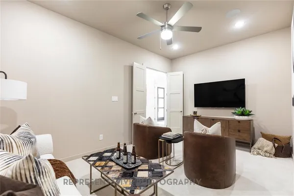 a living room with furniture and a potted plant