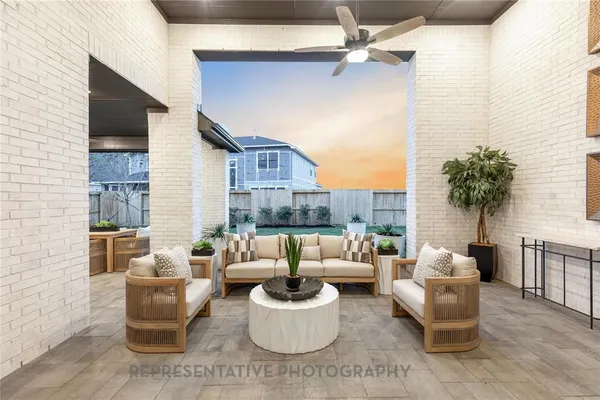 a living room with furniture and a potted plant