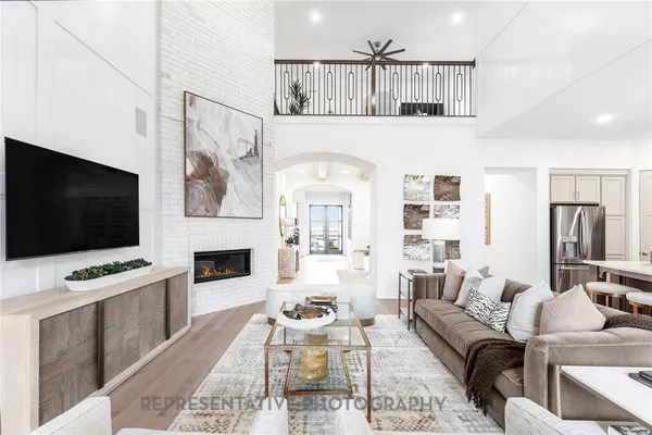 a living room with furniture a fireplace and a flat screen tv
