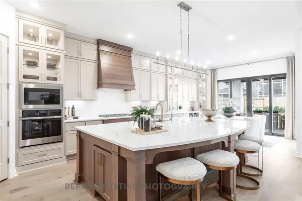 a kitchen with a dining table chairs and white cabinets