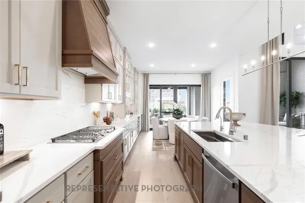 a kitchen with a sink stove top oven and cabinets