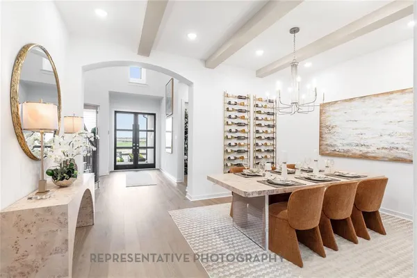 a view of a dining room with furniture wooden floor and chandelier