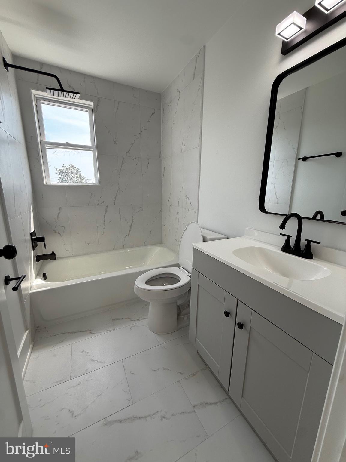 2125 Oakland Road Middle River, MD 21220 - Photo 12 of 15 a bathroom with a sink a toilet and a mirror