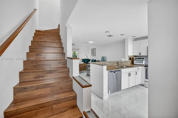 a kitchen with cabinets and white appliances