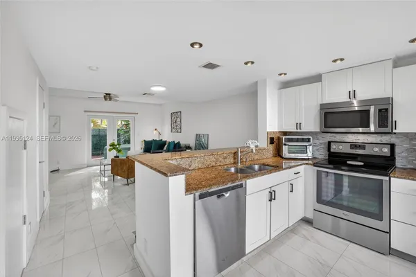 a kitchen with a sink stove and cabinets