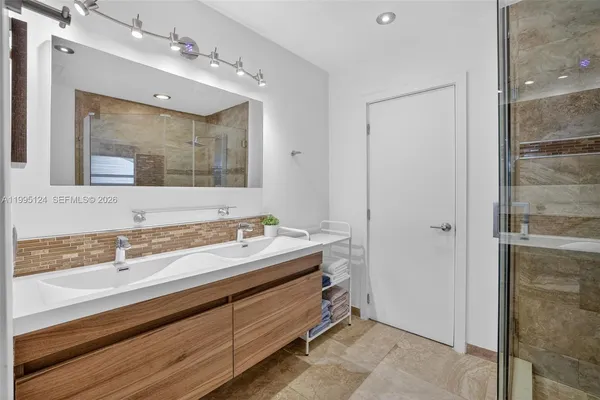 a bathroom with a sink and a mirror