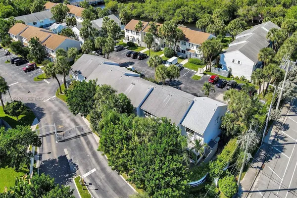 an aerial view of a house with a yard and garden
