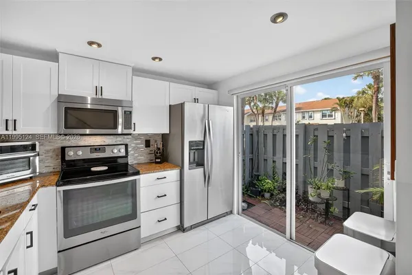 a kitchen with stainless steel appliances a refrigerator and a stove top oven