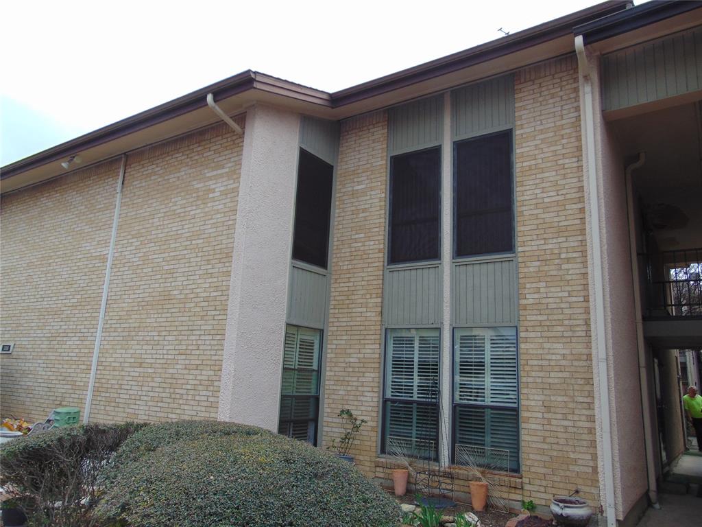 12806 Midway Road, Unit 2020 Dallas, TX 75244 - Photo 15 of 18 a brick house with a large window