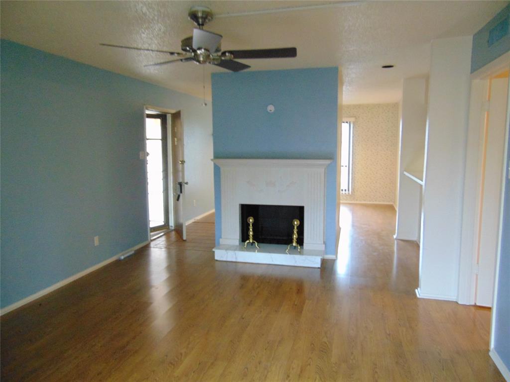 12806 Midway Road, Unit 2020 Dallas, TX 75244 - Photo 16 of 18 a view of a livingroom with a fireplace and window