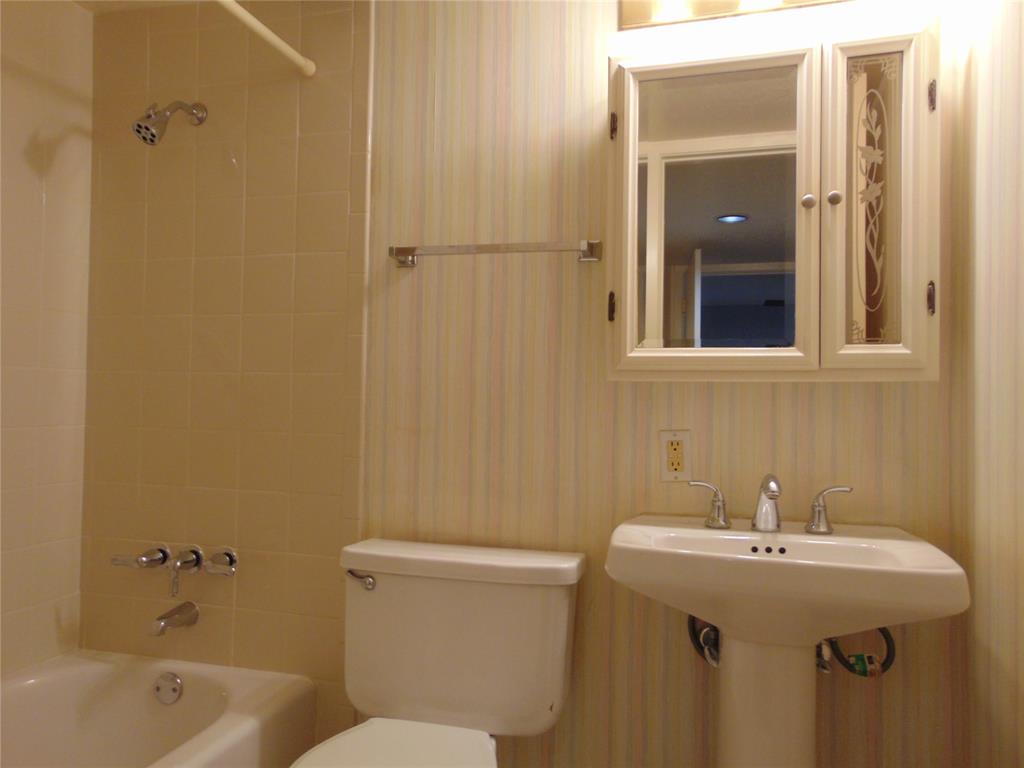 12806 Midway Road, Unit 2020 Dallas, TX 75244 - Photo 9 of 18 a bathroom with a sink and mirror with toilet