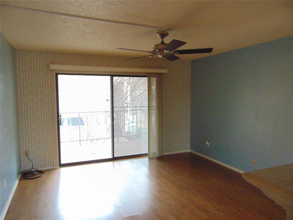 12806 Midway Road, Unit 2020 Dallas, TX 75244 - Photo 10 of 18 an empty room with wooden floor and windows