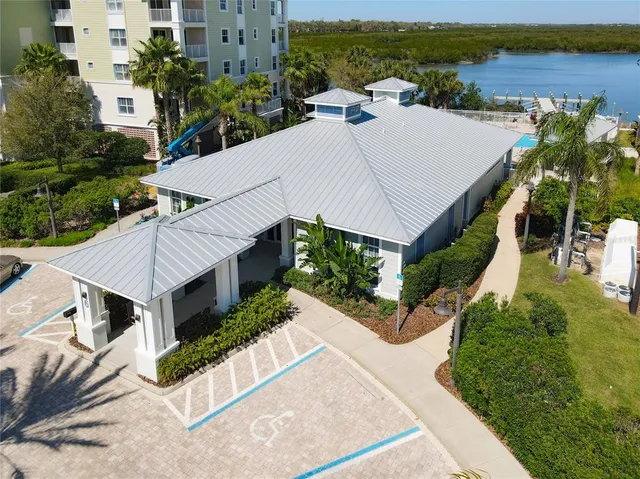 an aerial view of a house with a yard and balcony