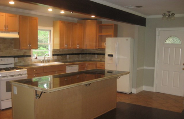 3220 Primrose Road Columbus, GA 31907 - Photo 5 of 16 a kitchen with stainless steel appliances granite countertop a refrigerator a sink a stove and a refrigerator with wooden floor