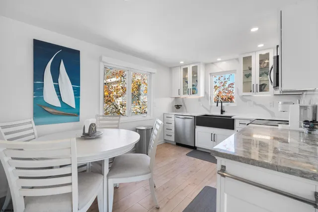a kitchen with white cabinets stainless steel appliances and sink