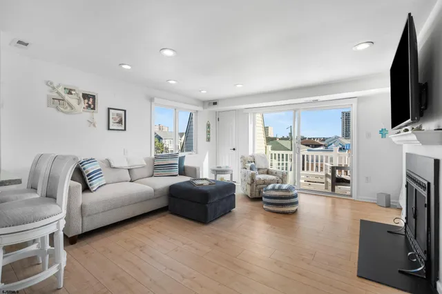 a living room with fireplace furniture and a flat screen tv