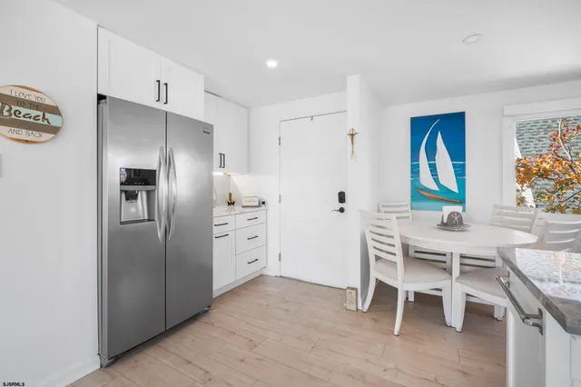 a kitchen with stainless steel appliances a refrigerator and a stove top oven