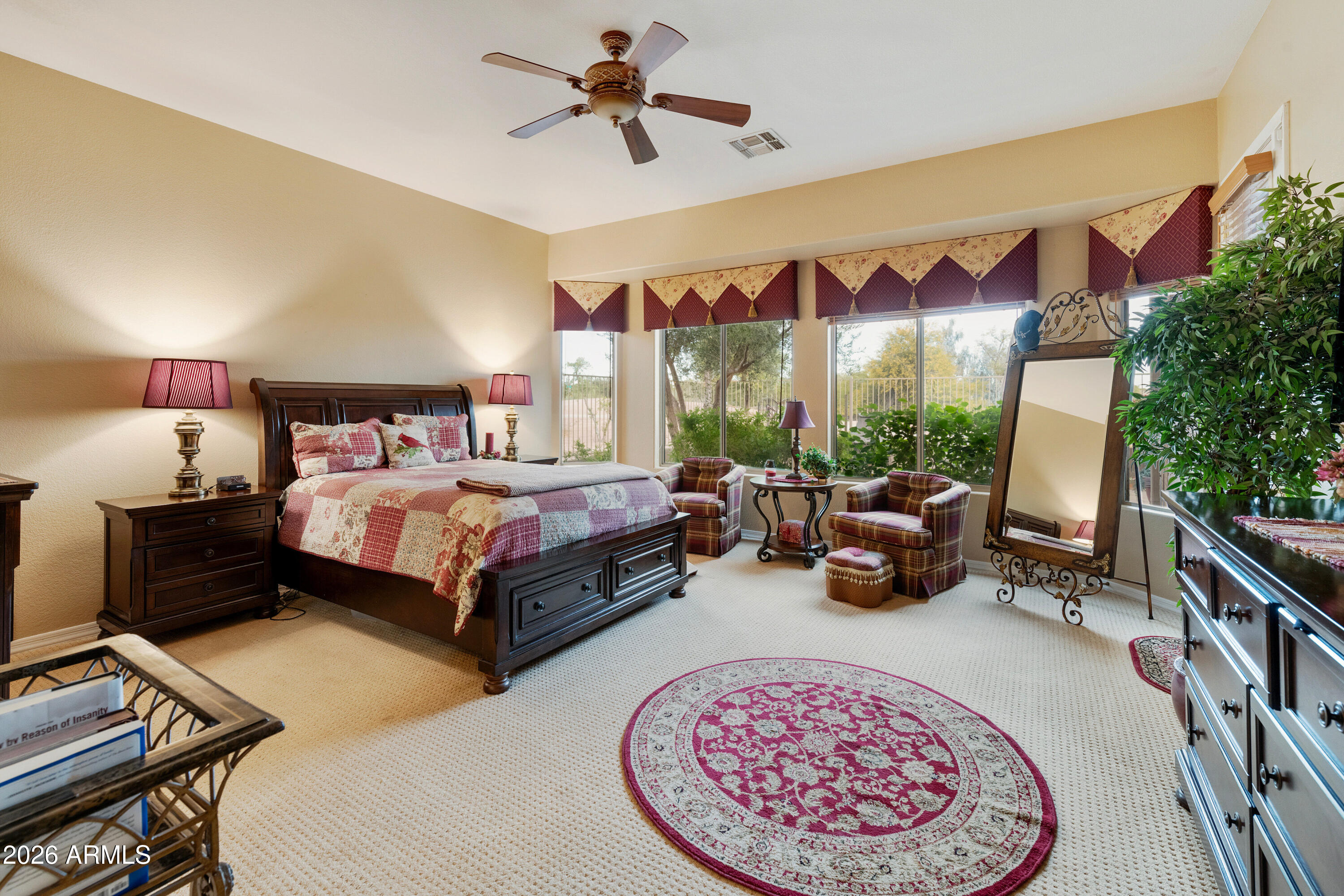 4100 East Strawberry Drive Gilbert, AZ 85298 - Photo 16 of 62 a bedroom with a bed a couch and a potted plant